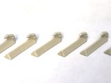 five pieces of white plastic on a white surface
