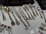 a lot of silver spoons and forks on the table