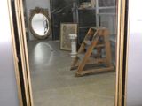 a mirror that is sitting on the floor in a room