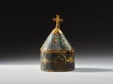 an image of a blue and gold vase with a cross on top