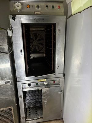 an oven that is sitting in the corner of a kitchen
