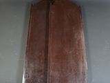 a wooden board hanging on a wall in a room