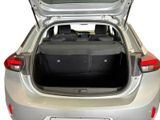the back of a silver car with its trunk open and luggage in the trunk