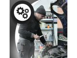 a man that is working on a car with a wren