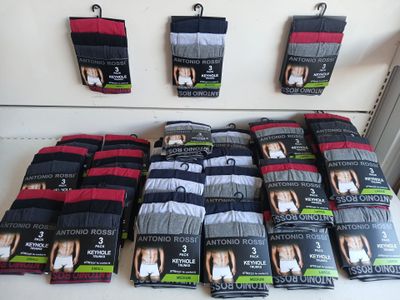 many pairs of men ' s underwear on display in a store
