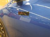 a close up of a blue car with a sticker on it