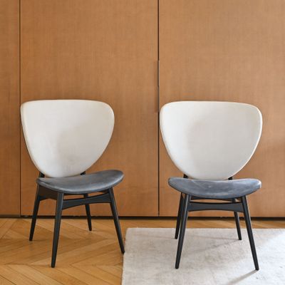 two chairs sitting next to each other in a room