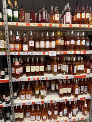 bottles of alcohol on a shelf in a store for sale