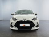 the front of a white toyota yaris parked in a white room