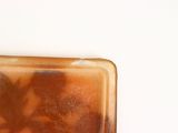 a glass plate with some food in it on a table