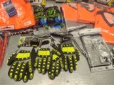 several pairs of gloves, gloves, gloves, and other items are on a table