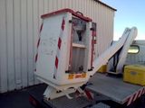 a white truck with a ramp attached to it ' s back