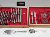 two trays with silverware in them on a table