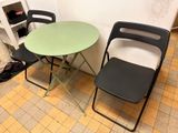 two chairs and a table in the corner of a room
