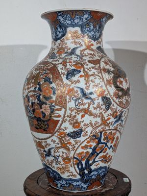 a vase that is sitting on top of a wooden stand