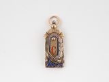 a picture of a silver and gold charm on a white surface