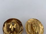 a close up of two gold buttons on a white surface
