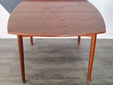 a small table with a wooden top on a wooden floor