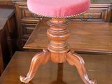 a wooden table with a pink stool on top of it