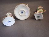 a small cup and saucer sitting next to a smaller cup and saucer