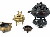 several different types of bronze objects are displayed on a white surface
