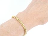 someone is wearing a bracelet with a gold chain on their wrist