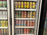 two refrigerators that have drinks in them in a store