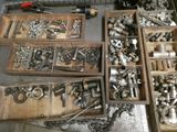 many different types of screws and nuts in a wooden box