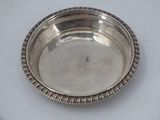 a silver plate on a table with a rope around it