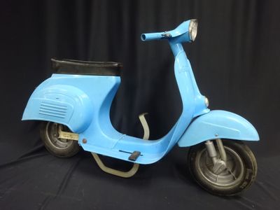 a blue scooter that is sitting on a black background