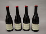 three bottles of wine are lined up on a table