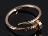 a close up of a gold ring on a black surface