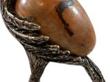 an image of a statue of a bird with a stone in its beak