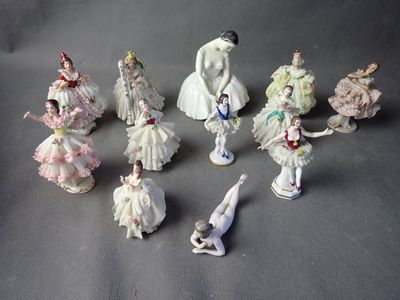 many figurines of women dressed in white and pink dresses