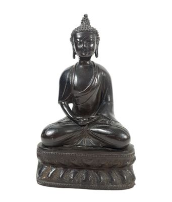 statue of a buddha sitting on a lotus - shaped base
