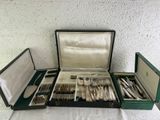 a lot of silverware in a case on a table