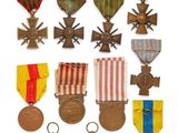 a group of medals and medals on display on a white surface