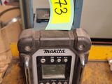 a radio sitting on top of a table with a yellow sticker on it