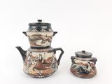 two teapots that are decorated with animals on them