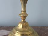 a gold candle that is sitting on a marble table