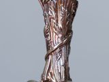 a silver vase that has a bunch of flowers inside of it