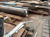 a truck that is parked next to a pile of wood