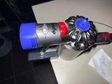 a small blue and red vacuum on a counter