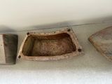 three pieces of pottery sitting on the floor next to each other