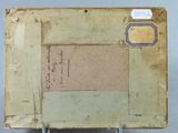 an old book with a piece of paper on top of it
