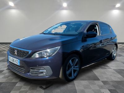 the blue car is parked on a checkered floor in a room