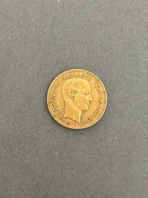 a gold coin with a profile of a man ' s head on it