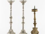 three silver candlesticks on a white background with a white background