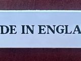 a sign that says made in england on a wooden table