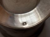 a close up view of a metal bowl with a hole in it